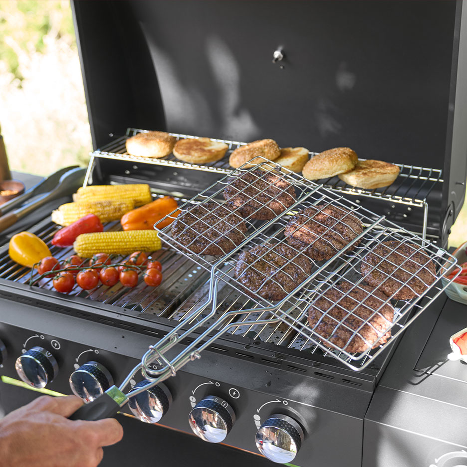 Gas grill with burgers, corn on the cob, and buns on the grate.