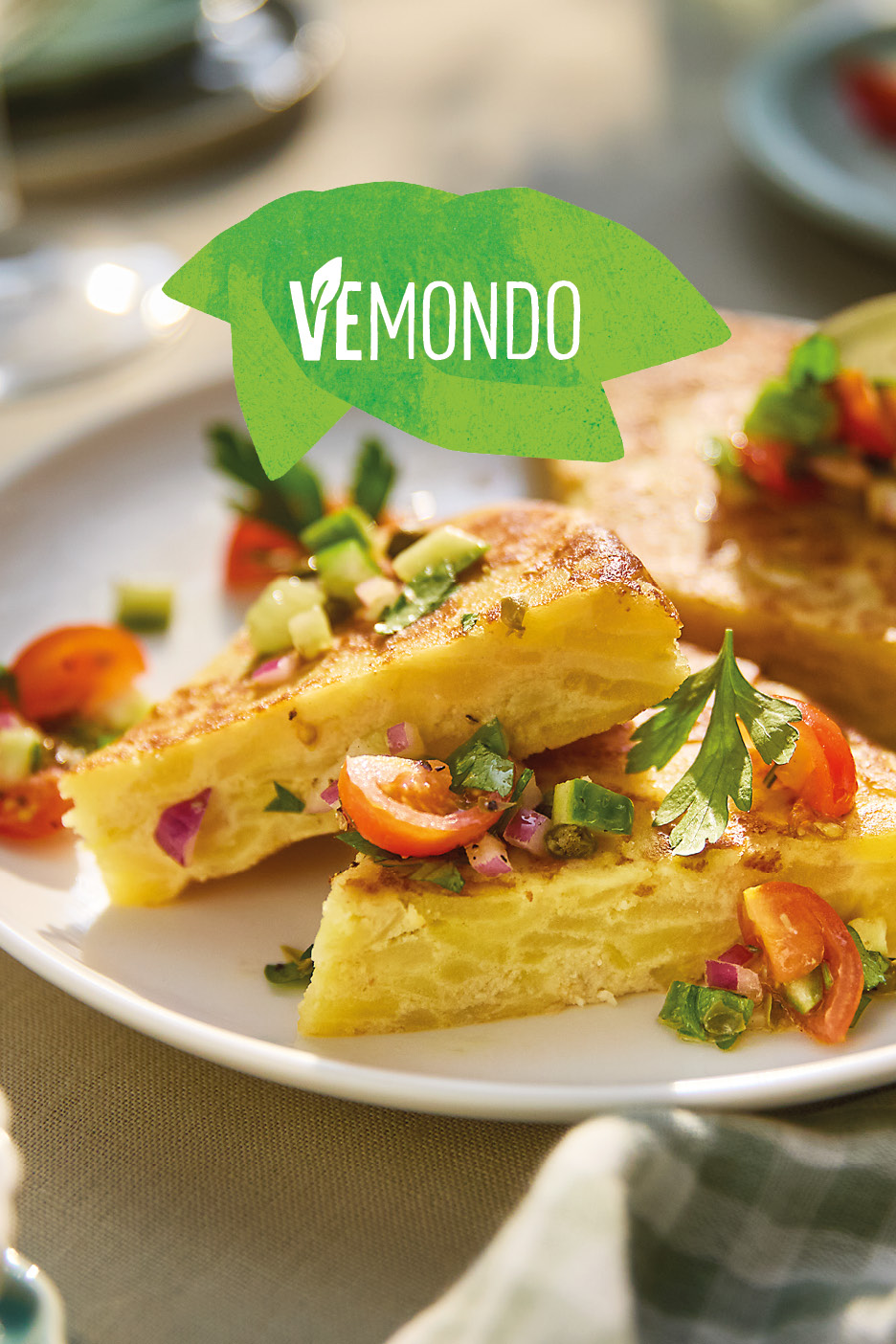 Potato omelet slices with fresh salsa on a white plate, with a green VEMONDO logo.