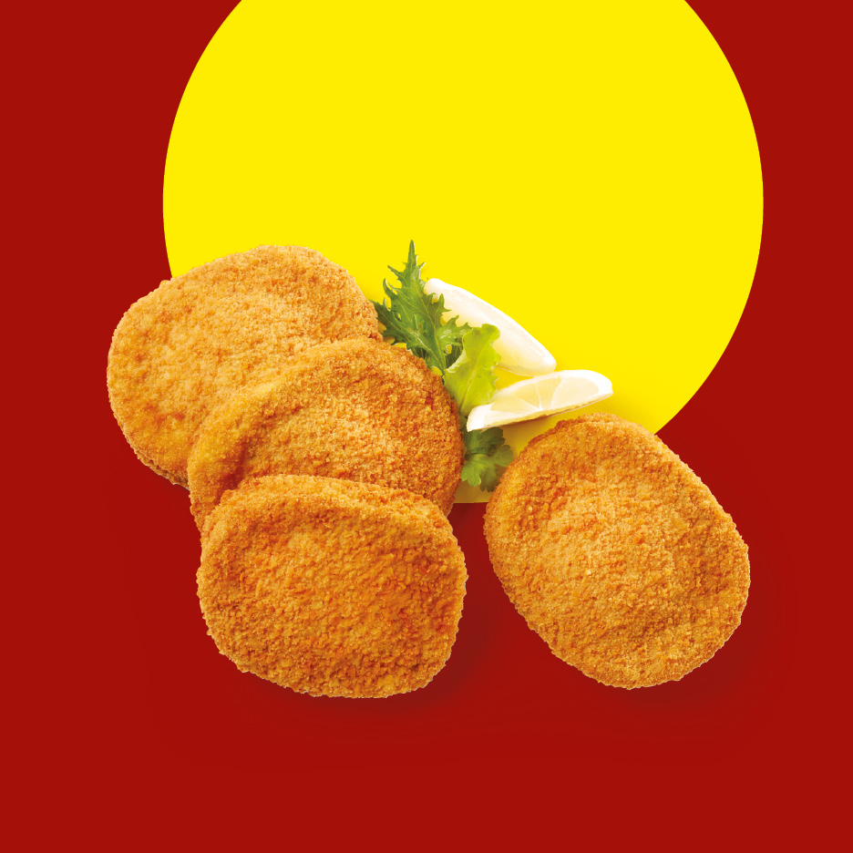 Breaded chicken cutlets with lemon wedges and lettuce on a red and yellow background.