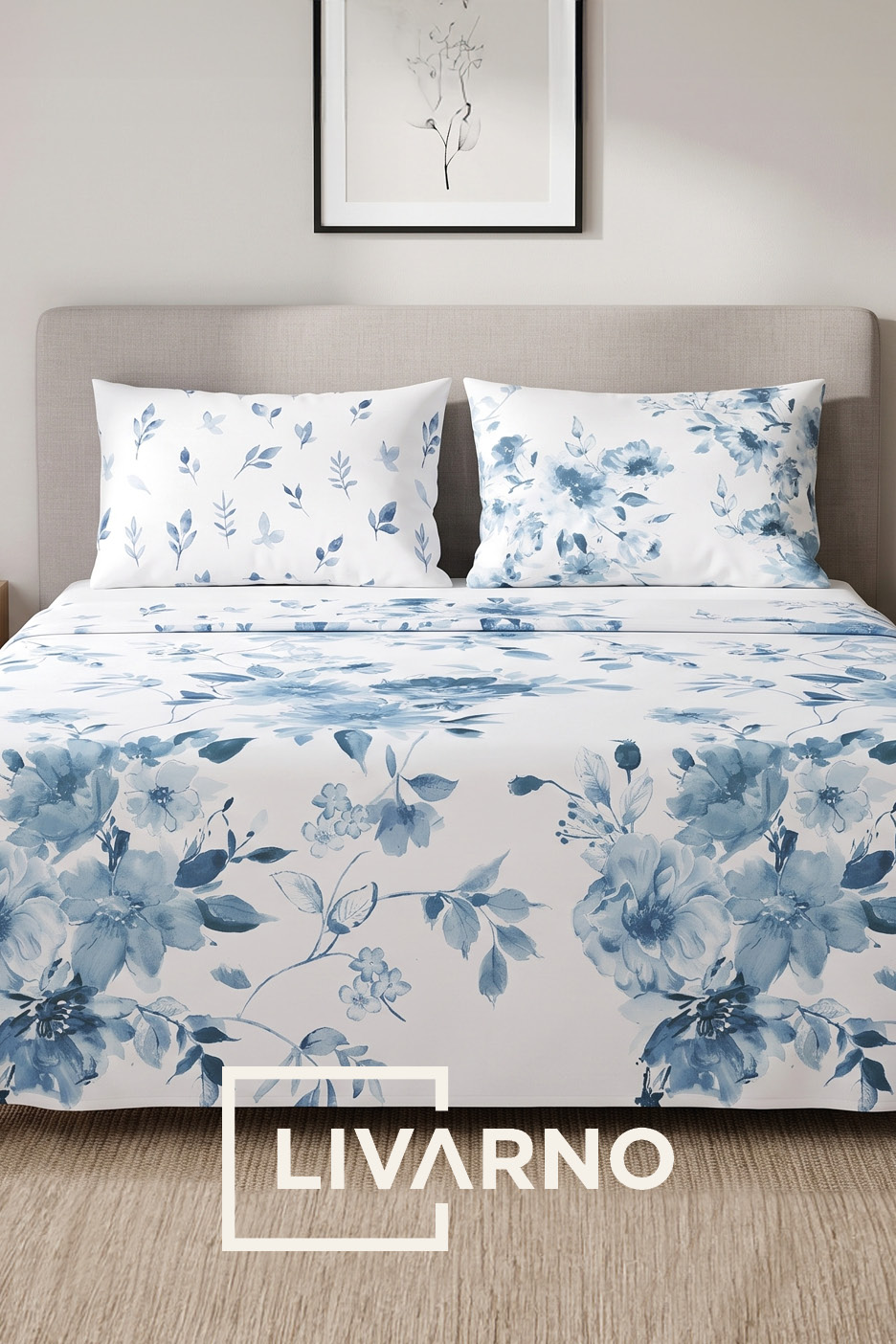 Bed with white bedding featuring blue floral and leaf patterns, with a framed picture above.