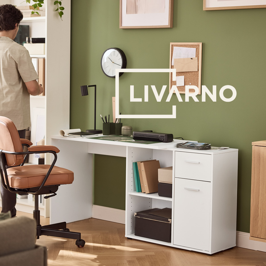 Home office with white desk, storage unit, and brown swivel chair, against a green wall.