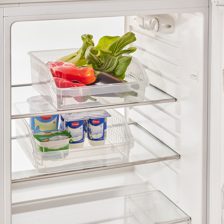 Refrigerator with clear organizers filled with vegetables, yogurts, and cheese.